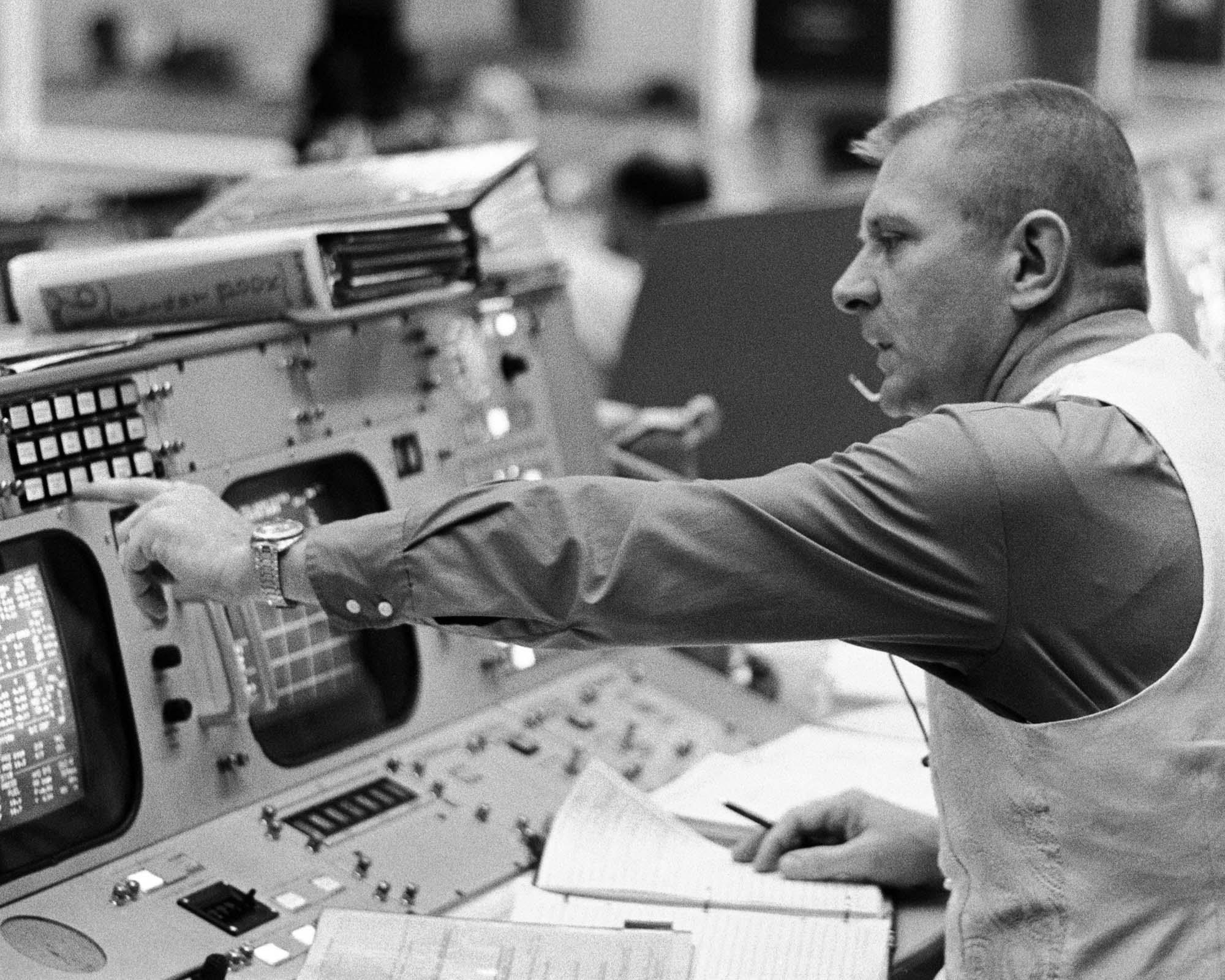 Flight director Eugene F. Kranz is seated at his console in the mission operations control
                          room in the Manned Spacecraft Center's Mission Control Center on the morning of the launch of
                          the Apollo 16 lunar landing mission.